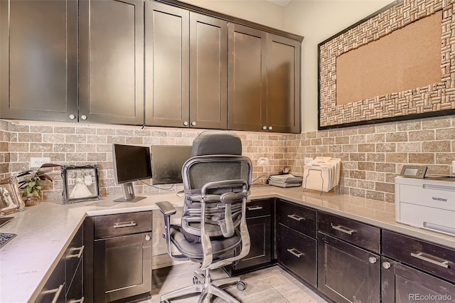 office area featuring light tile patterned floors and built in desk