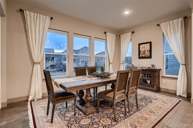 dining room with recessed lighting, hardwood / wood-style flooring, and baseboards