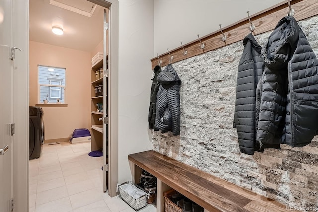 mudroom featuring washer / clothes dryer and light tile patterned flooring