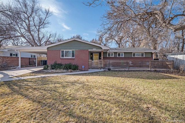 single story home featuring a front lawn, fence, driveway, and a carport