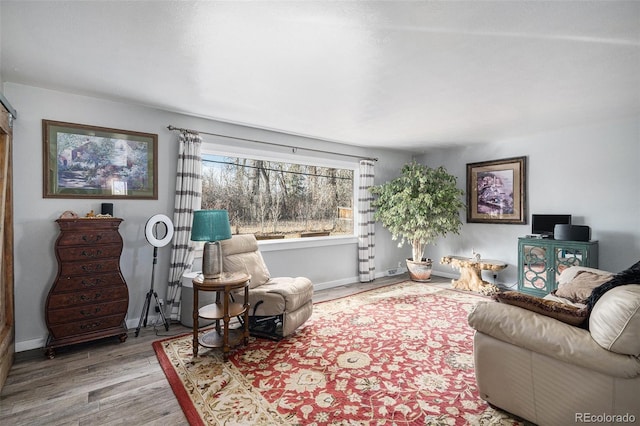 living room featuring wood finished floors and baseboards