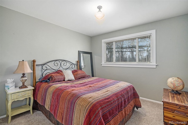 carpeted bedroom featuring baseboards