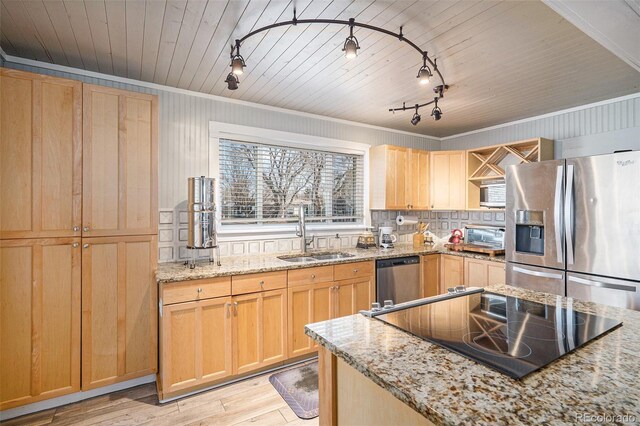 kitchen with light brown cabinets, light wood-type flooring, a sink, appliances with stainless steel finishes, and tasteful backsplash