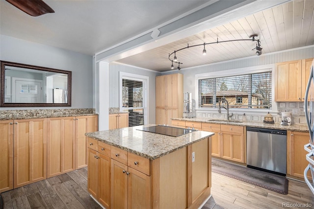 kitchen with light brown cabinetry, a sink, black electric stovetop, and stainless steel dishwasher