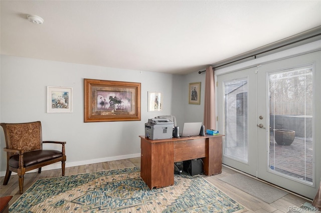 office with light wood-style flooring, french doors, and baseboards