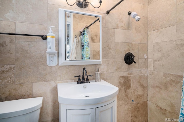 bathroom featuring vanity, toilet, and a tile shower