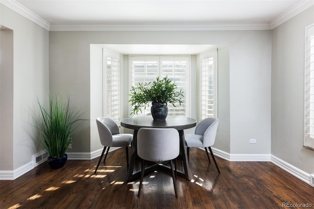 dining space with dark hardwood / wood-style floors and ornamental molding