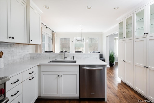 kitchen with sink, hanging light fixtures, white cabinets, and dishwasher