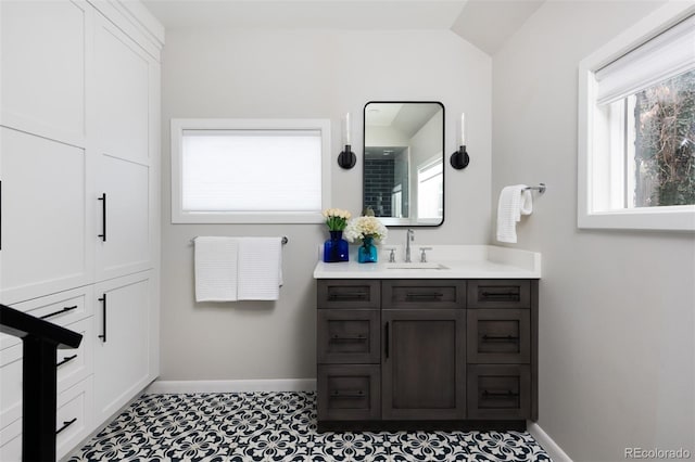 bathroom with vanity and vaulted ceiling