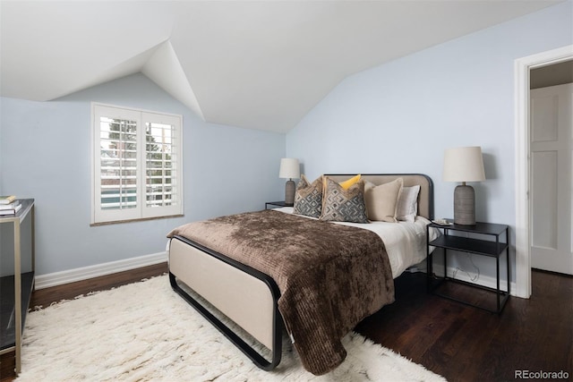 bedroom featuring dark hardwood / wood-style floors and lofted ceiling