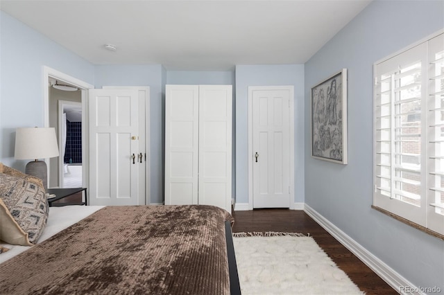 bedroom with dark hardwood / wood-style flooring