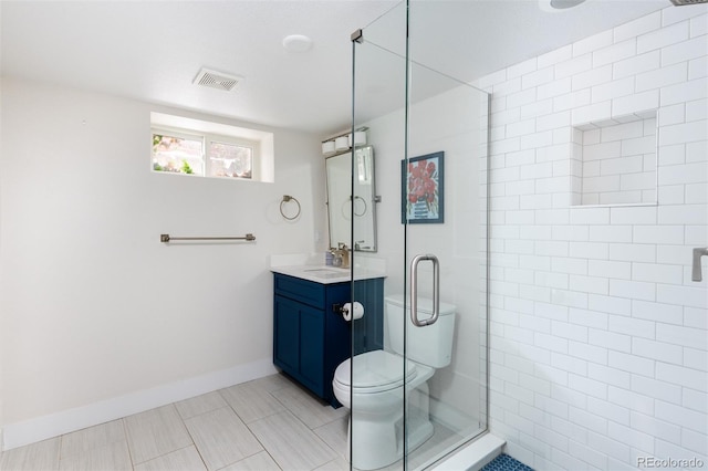 bathroom with toilet, an enclosed shower, tile patterned floors, and vanity