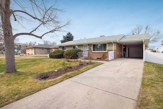 ranch-style home featuring a front lawn and a carport