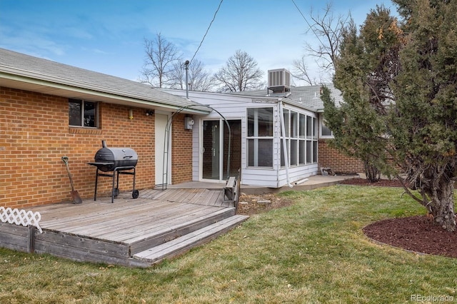 back of house with a lawn, a wooden deck, a sunroom, and cooling unit