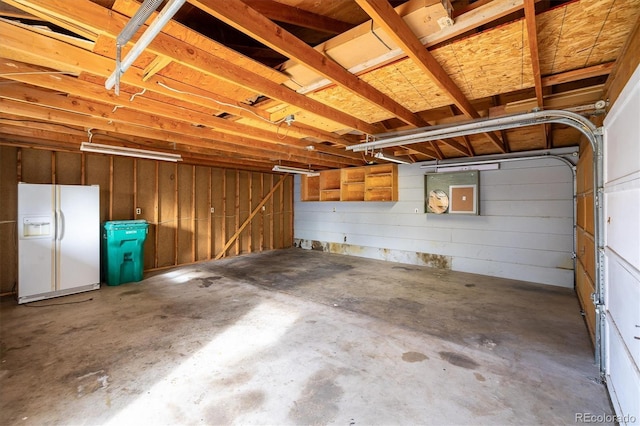 garage with white refrigerator with ice dispenser