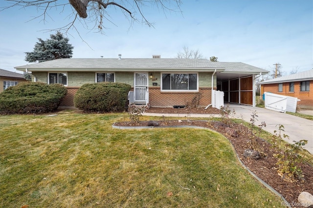 single story home featuring a front lawn and a carport