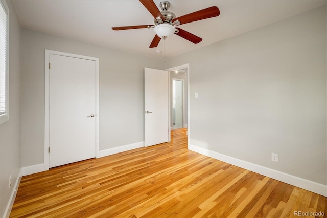 unfurnished bedroom with ceiling fan and light hardwood / wood-style flooring