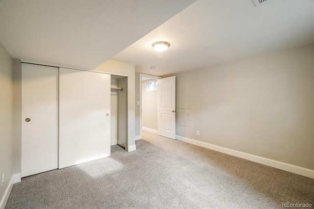 unfurnished bedroom with carpet flooring and a closet