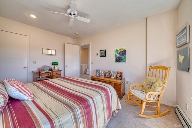 carpeted bedroom featuring baseboards, a baseboard radiator, and a ceiling fan