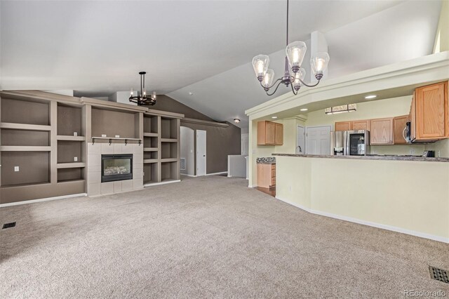 903 Cameron Dr, Severance, CO 80550 - unfurnished living room featuring a chandelier, vaulted ceiling, light carpet, and a fireplace