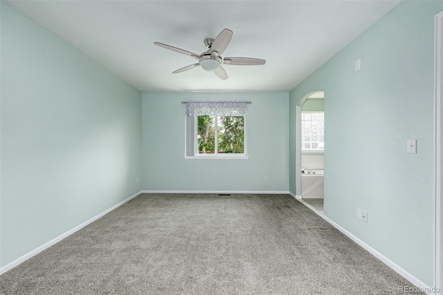 903 Cameron Dr, Severance, CO 80550 - carpeted spare room featuring arched walkways and a ceiling fan