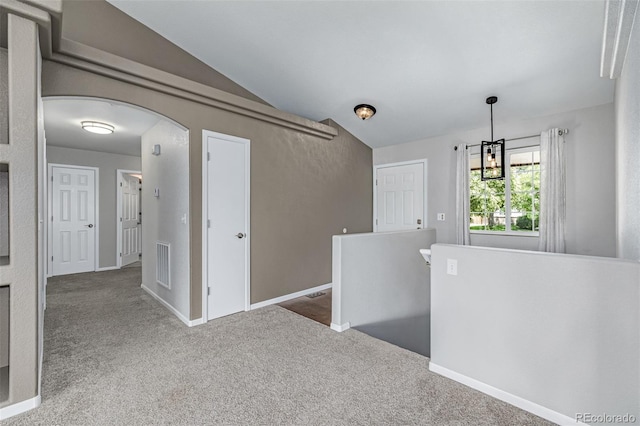 903 Cameron Dr, Severance, CO 80550 - empty room featuring arched walkways, carpet, and a chandelier