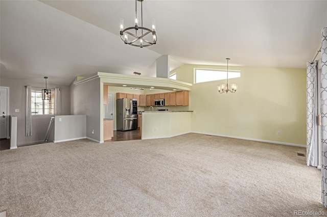 903 Cameron Dr, Severance, CO 80550 - unfurnished living room with a chandelier, lofted ceiling, and dark carpet