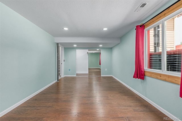 903 Cameron Dr, Severance, CO 80550 - unfurnished room with wood finished floors, a textured ceiling, and recessed lighting