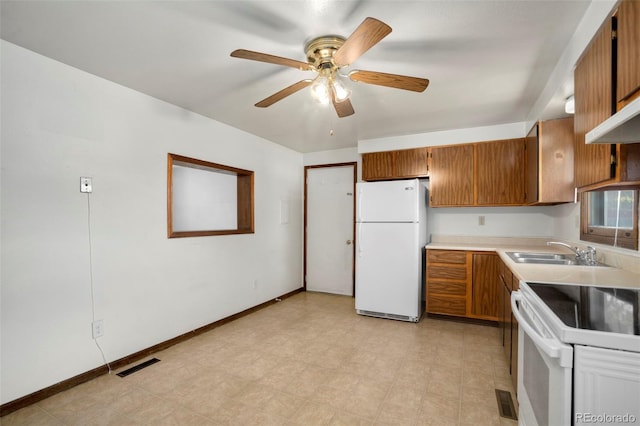 kitchen featuring ceiling fan, sink, and white appliances