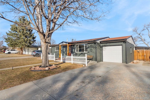 single story home featuring brick siding, an attached garage, concrete driveway, and fence