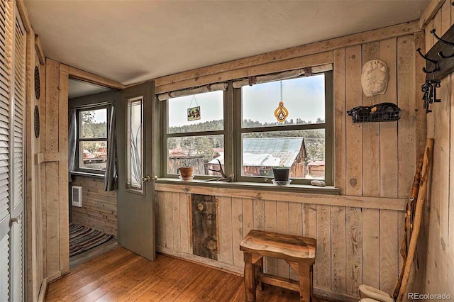 interior space featuring wood walls and hardwood / wood-style floors