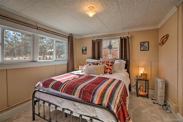 carpeted bedroom with crown molding and multiple windows