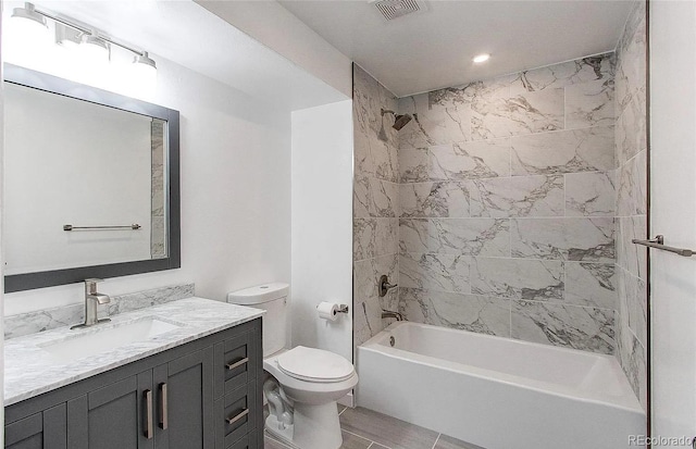 full bath featuring toilet, bathing tub / shower combination, vanity, and visible vents