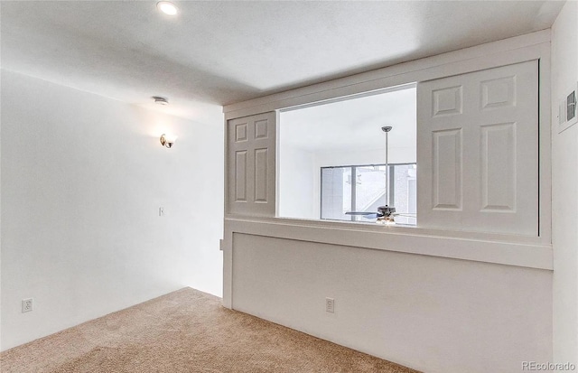 carpeted spare room featuring visible vents