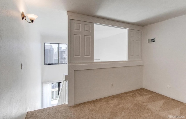 carpeted spare room with visible vents