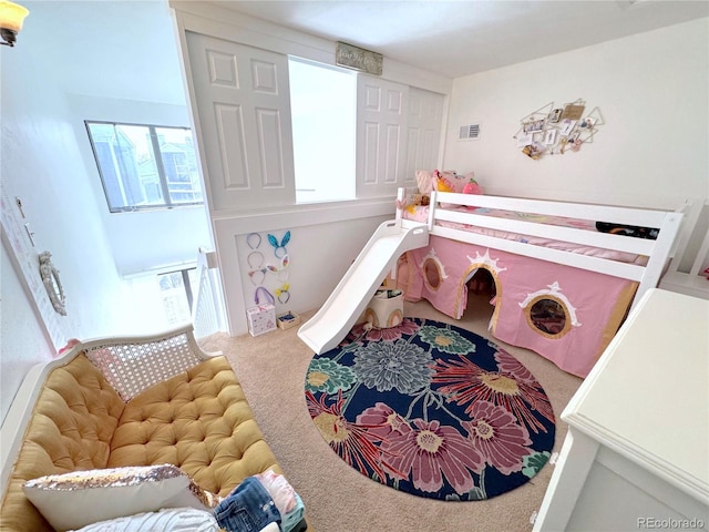 carpeted bedroom featuring multiple windows and visible vents