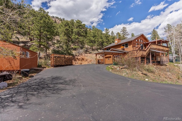 29 Cedar Ln, Bailey, CO 80421 - chalet / cabin with driveway, a chimney, and a wooden deck