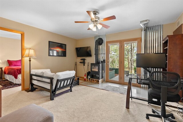 29 Cedar Ln, Bailey, CO 80421 - carpeted bedroom featuring a wood stove, access to outside, and a ceiling fan