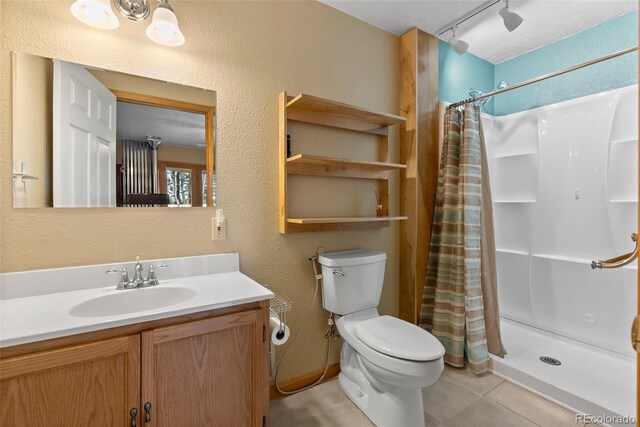29 Cedar Ln, Bailey, CO 80421 - full bathroom featuring tile patterned flooring, a stall shower, vanity, toilet, and a textured wall