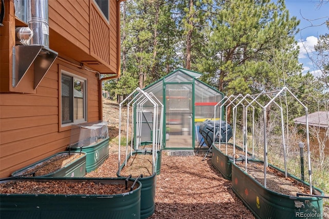 29 Cedar Ln, Bailey, CO 80421 - view of yard featuring a greenhouse, an outdoor structure, and a garden