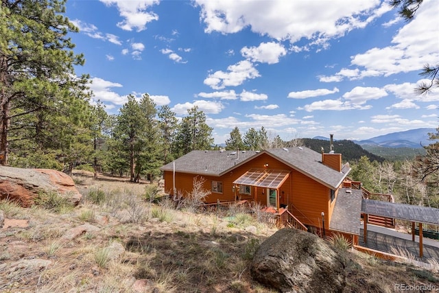 29 Cedar Ln, Bailey, CO 80421 - back of property featuring a chimney and a mountain view
