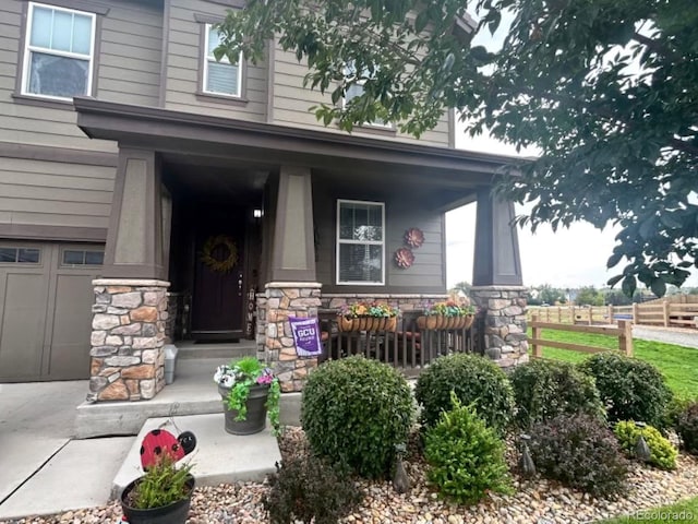 entrance to property with a porch and a garage