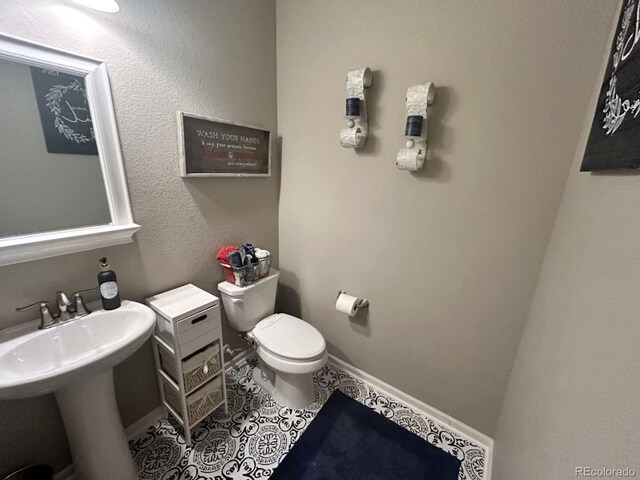 bathroom featuring tile patterned floors and toilet