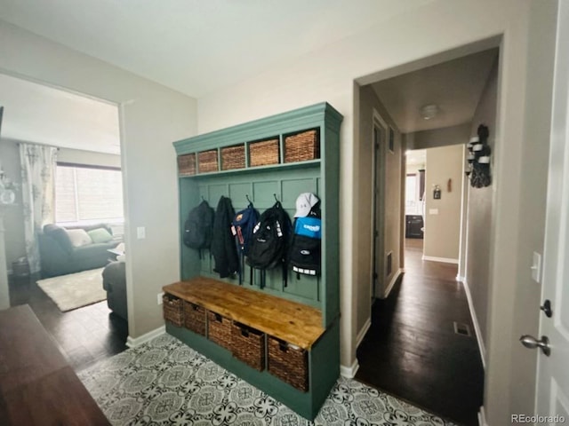 mudroom featuring baseboards and wood finished floors