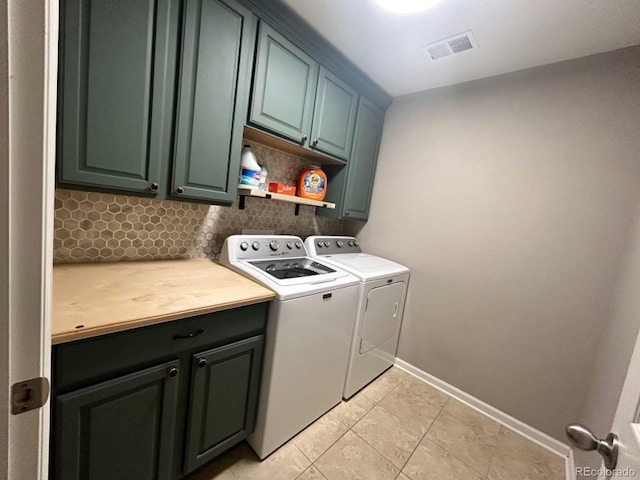 washroom featuring light tile patterned floors, cabinet space, visible vents, separate washer and dryer, and baseboards