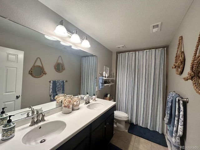 full bath with a sink, a textured ceiling, and toilet