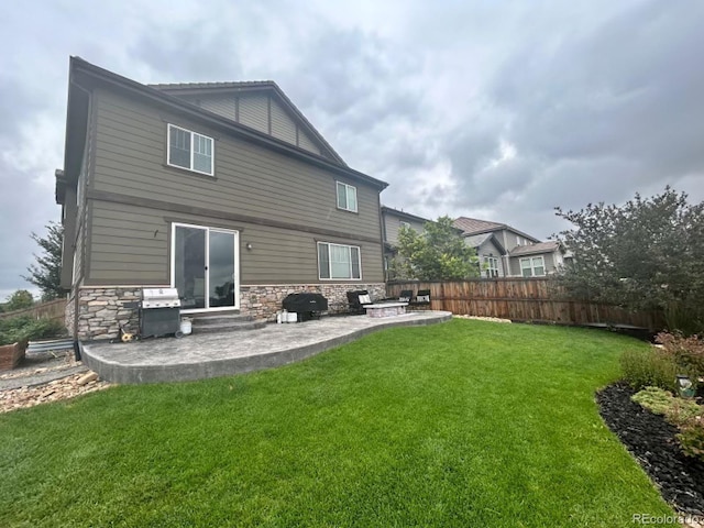 rear view of house with a patio area and a yard