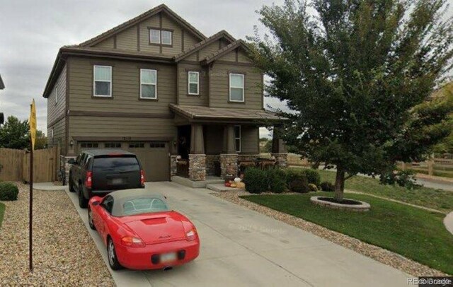 craftsman-style home featuring a front lawn and a garage