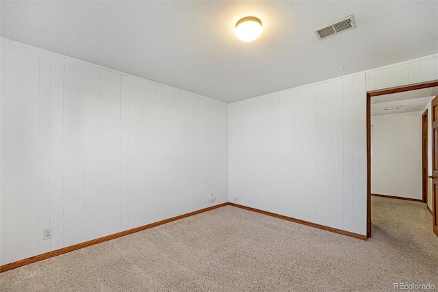 spare room featuring carpet floors and visible vents