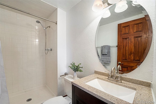 full bathroom featuring toilet, a shower stall, and a textured wall